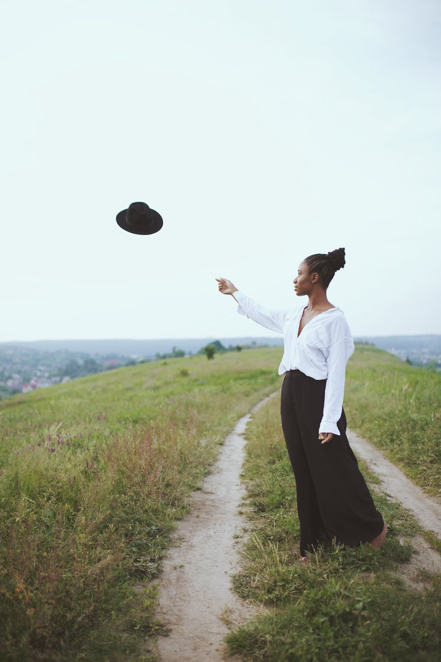 photo of woman throwing her hat